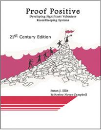 Book cover with title, stick figures walking up a pile of papers and putting flag at top